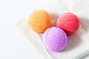 Colorful bath bombs resting on a soft towel ready for a relaxing bath experience