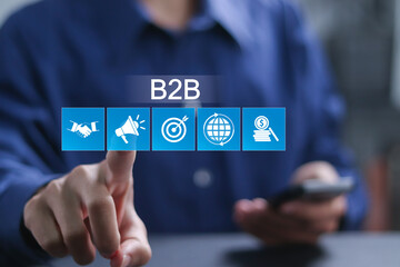 B2B marketing concept, business to business, e-commerce, Businessman touching to B2B icons for collaboration and partnership.