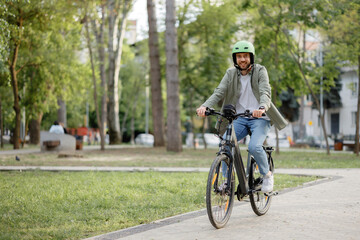 Naklejka premium Enjoying a leisurely ride on an electric bicycle in a city park during a sunny afternoon