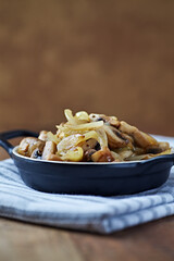 Onion with mushrooms. Rustic wooden background.