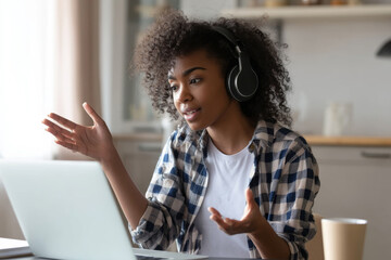 Young adult Black woman attending a virtual training session on diversity and inclusion, interacting actively in the chat