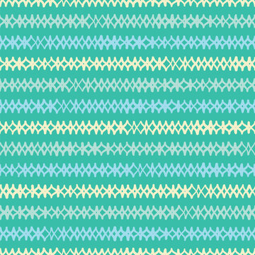 Hand drawn diamonds pattern background tile. Doodle argyle design vector seamless in yellow, blue and green.