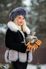 Portrait of a young beautiful blonde model-looking girl in winter clothes and a fur hat in winter.