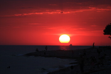 ship in the disk of the setting sun on the coast of the black sea