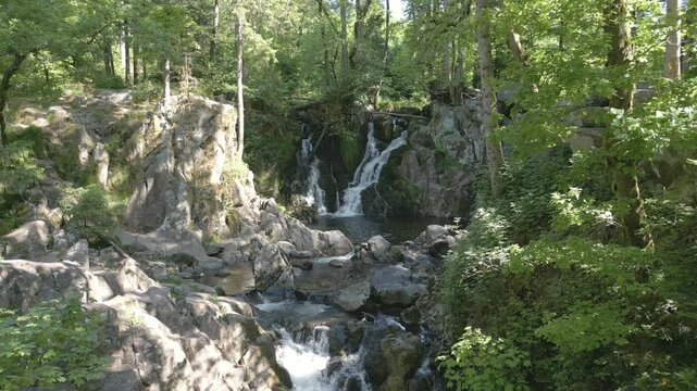 Drone qui survole en descendant une magnifique cascade sur plusieurs niveaux dans la for&ecirc;t des Vosges : le Bouchot