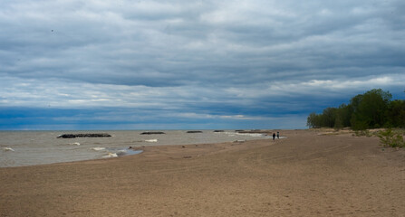 A chilly beach under cloudy skies at Presque Isle State Park on Lake Erie.
