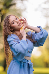 Beautiful Girl with long hair posing in sunbeams in park
