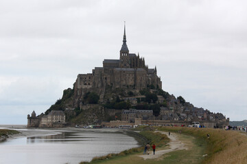 view of famous Le Mont Saint-Michel tidal island in beautiful twilight during blue hour at dusk, Normandy, France