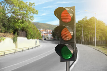 Traffic lights on empty road. Signaling device