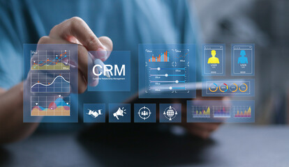 Customer relationship management software concept. Businessman using tablet with CRM icon on...