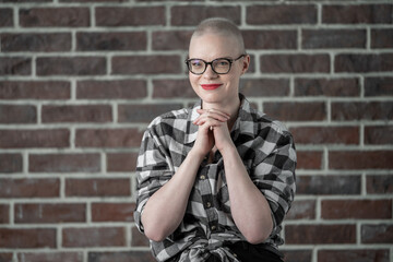 Portrait of a beautiful young caucasian woman with shaved head. Female cancer survivor. Smiling...