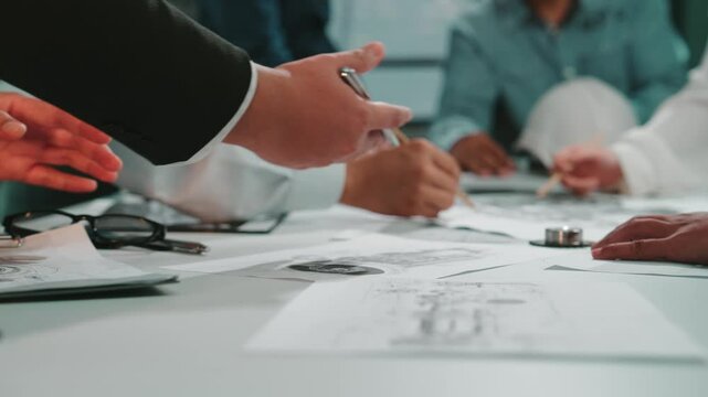 A diverse group of business professionals actively collaborates on important project documents and strategies in a modern office setting, showcasing teamwork and innovation. SACTR