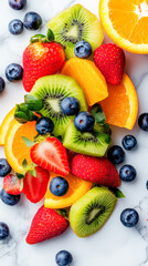 Obraz premium A colorful variety of fresh fruits, including strawberries, blueberries, kiwi, and orange slices, arranged on a marble countertop