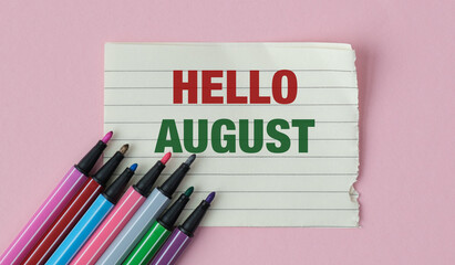 A colorful set of markers is on a piece of paper with the word Hello August written © Pawel