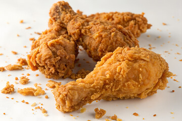 Close-up shot of crispy, golden-brown fried chicken drumsticks, showcasing delicious texture.