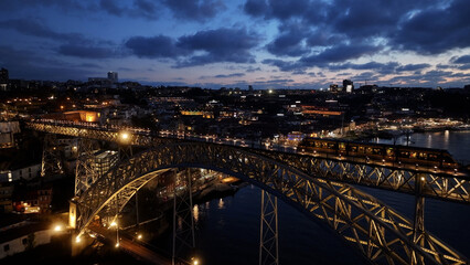 Sunset Dom Luis I Bridge At Porto In District Of Porto Portugal. Sunset Skyline Scene. Illuminated Bridge Landscape. Dom Luis I Bridge At District Of Porto Portugal. Railroad Transport. 