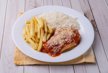 Parmegiana chicken breast, rice and french fries. Typical brazilian executive dish