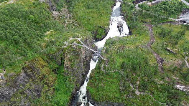 bridge over voringsfossen waterfall on green mountain in Hardangervidda National park in Norway