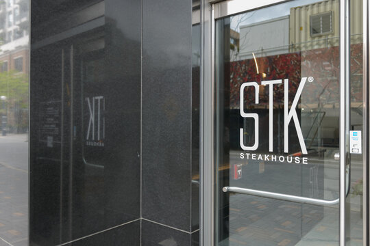 exterior building and entrance door with sign of STK Steakhouse located at 153 Yorkville Av, Toronto