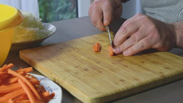 Cutting carrots into small lengthwise pieces for perfect meal preparation at home