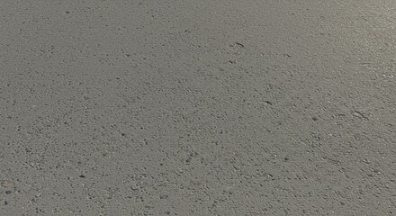 Light gray concrete surface, speckled with small particles