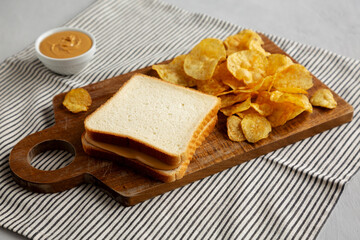 Homemade American Peanut Butter Sandwich on a Wooden Board, side view.