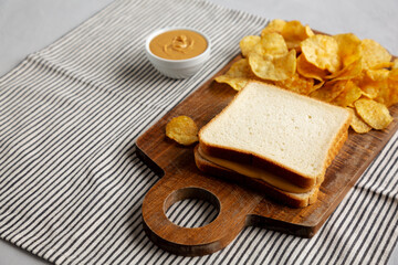 Homemade American Peanut Butter Sandwich on a Wooden Board, side view.