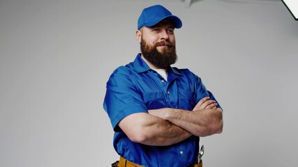 Confident Mechanic in Blue Uniform
