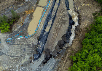 The place where the Corund stream eroded the soil and entered the salt mine in Praid - Romania. Aerial view of the hole where the Corund river floods the Praid salt mine