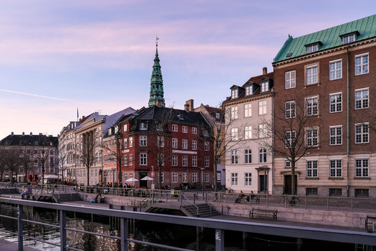 View of Ved Stranden, a historic waterfront street lined with colorful 18th-century buildings, offering picturesque scenes along the canal near Christiansborg Palace.