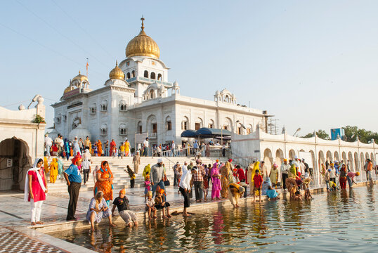 Followers by the 'Sarovar' pond whose water is considered holy, inside Gurudwara Bangla Sahib, Delhi, India, Asia