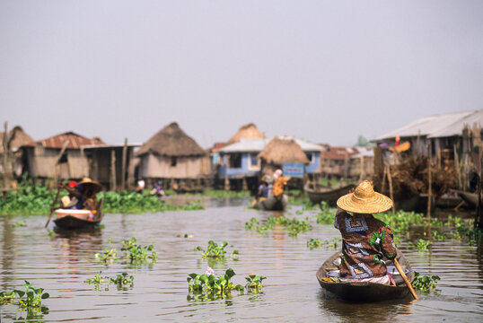 Villagers moving by pirogue on Ganvie lake village in Lake Nokou, near Cotonou, Benin