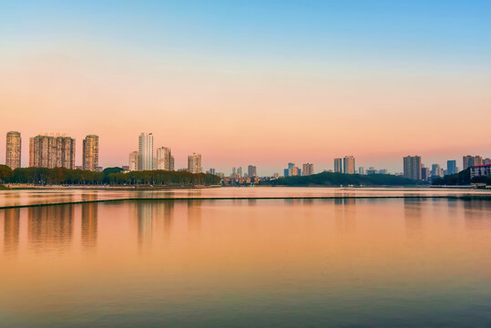 Cityscape of Jiujiang City at sunset over the Sai Lake, Jiangxi Province, China