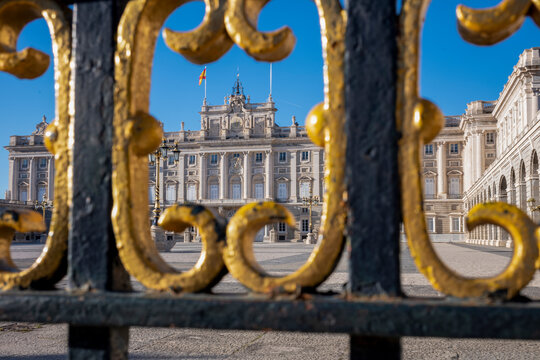 Palacio Real (Royal Palace) through decorative fencing, in the heart of the capital city of Madrid, Spain