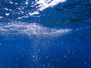 Bubbles underwater rising to water surface, natural scene bubble under water, Mediterranean sea,...