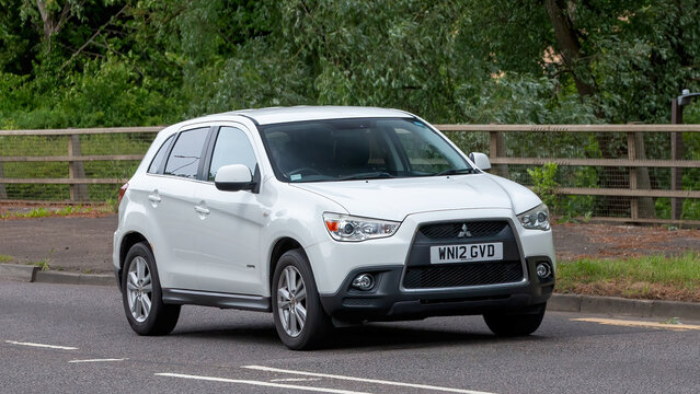 Milton Keynes,Bucks,UK - May 29th 2025:  2012 white Mitsubishi ASX car driving on a British road.