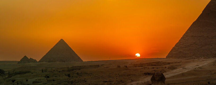 View of Giza Pyramids from rooftop terrace at sunset, Cairo, Egypt, Africa