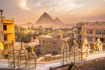 View of the Giza Pyramids from rooftop terrace during golden hour, Giza, Cairo, Egypt, Africa