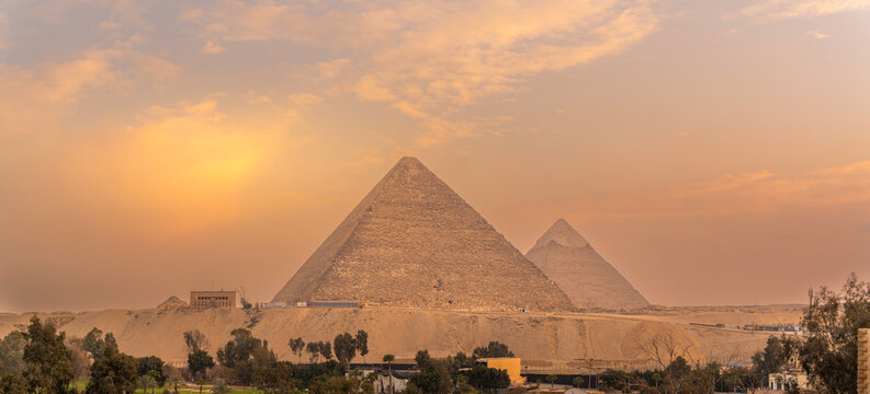 View of the Giza Pyramids from rooftop terrace during golden hour, Giza, Cairo, Egypt, Africa