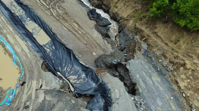 Aerial footage of the place where the Corund River enters the salt mine in Praid, Harghita County - Romania. The hole where the water floods into the Praid salt mine