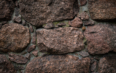Сlose-up of a wall made of large granite boulders