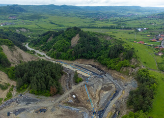The place where the Corund stream eroded the soil and entered the salt mine in Praid - Romania. Aerial view of the hole where the Corund river floods the Praid salt mine