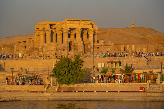 View of Kom Ombo Temple on the Nile river from cruise boat at sunset, Aswan, Nubia, Egypt, North Africa, Africa