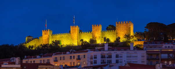 View of hilltop Castelo de Sao Jorge, (Lisbon Castle) illuminated at dusk, Lisbon, Portugal, Europe