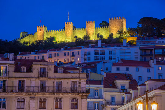 View of hilltop Castelo de Sao Jorge, (Lisbon Castle) illuminated at dusk, Lisbon, Portugal, Europe