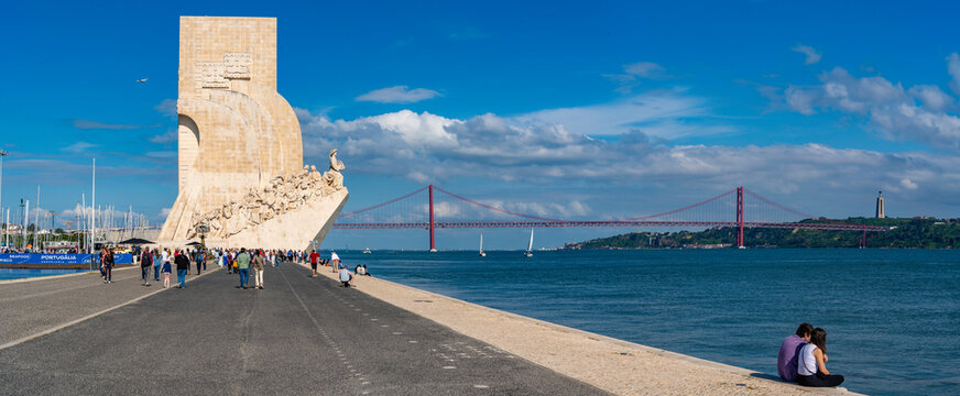 View of Monument to the Discoveries (Padrao dos Descobrimentos) and 25 April Bridge on a sunny day, Lisbon, Portugal, Europe