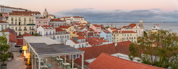 View of colourful buildings and red rooftops at sunset in the Alfama District, Lisbon, Portugal, Europe