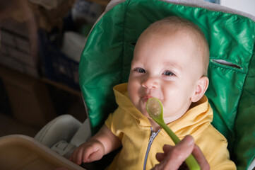 Happy Baby Being Fed by Grandmother at Home