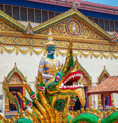 Mythical figures, deities and thai dragon (half snake), guard the entrance of the reclining buddha pavillion in the Wat Chayamangkalaram temple complex, George Town, Penang, Malaysia.