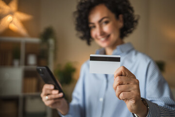 Mature adult woman buy online on mobile phone and use credit card